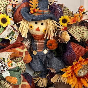 Fall Wreath, Thanksgiving, Scarecrow, Hay Bail, fall flowers and ribbon. Mesh wreath stuffed full of goodies.