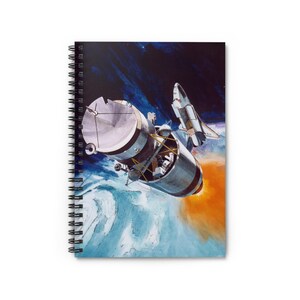 May include: Spiral-bound notebook featuring a vintage illustration of a spacecraft and space shuttle in the cosmos. The artwork depicts a detailed view of the spacecraft with a fiery orange exhaust against a backdrop of blue and black space.
