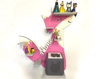 May include: Pink fox-shaped wall shelf with multiple shelves, featuring a variety of figurines, including princesses, a wolf, and a dog. The shelf also includes a small grey speaker with a black speaker grille. The word "Name" is written on the shelf in white letters.