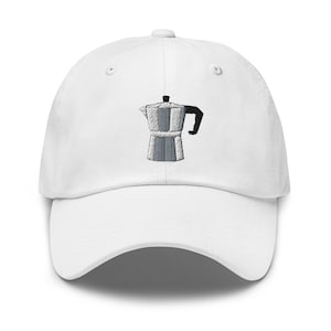 May include: White baseball cap with an embroidered design of a silver and black stovetop espresso maker. The cap has a curved brim and a button on top. A stylish accessory for coffee lovers.