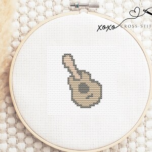 May include: A cross-stitched design of a hand giving a thumbs up, with the text "xoxo cross-stitched" above it.