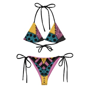 May include: A black and pink bikini with a patchwork design featuring yellow, blue, and pink fabric. The bikini top has a triangle shape and adjustable straps. The bikini bottom has a low-rise cut and ties on the sides.