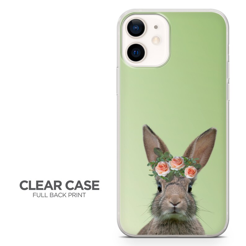 May include: A clear phone case with a full back print of a brown rabbit wearing a flower crown with pink flowers and green leaves on a light green background.