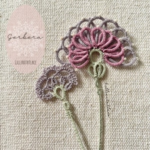 May include: A tatting lace applique featuring two floral motifs with stems. The larger flower has pink petals and a grey outer ring with small white beads. The smaller flower is light purple. Both have light green stems and intricate thread loops.