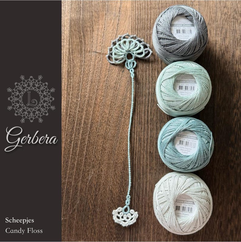 May include: A light green crocheted bookmark with a fan-shaped top and bottom, positioned next to four round balls of Scheepjes Candy Floss yarn in shades of grey, mint green, teal, and off-white, each featuring a white label with text.