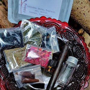 May include: A red glass plate with a protection spell bottle kit. The kit includes herbs, crystals, oil, a bottle, incense, and instructions. The kit is packaged in clear plastic bags.