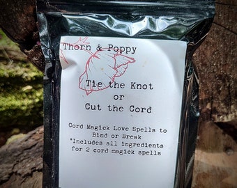 May include: A black zippered pouch with a white label that reads "Thorn & Poppy Tie the Knot or Cut the Cord Cord Magick Love Spells to Bind or Break *Includes all ingredients for 2 cord magick spells"