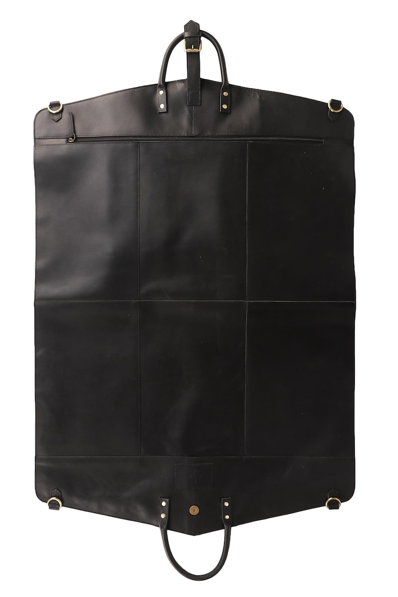 May include: A black leather garment bag with a top handle, a smaller handle at the bottom, and a zipper closure. The bag has gold-colored hardware and a rectangular shape with a curved top.