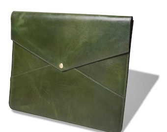 May include: A dark olive green leather document folder with an envelope-style flap closure. The folder features a smooth, slightly glossy finish and a single centered gold-toned metal snap button fastener at the point of the triangular flap.