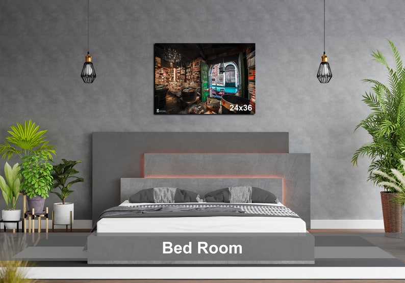 May include: A gray upholstered bed with a headboard and a gray bedspread. The bed is in a room with a gray wall and a framed picture of a bookstore interior. The picture is labeled "24x36".