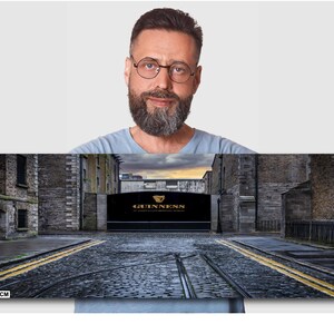 May include: A panoramic photo of a cobblestone street in Dublin, Ireland. The street is lined with old brick buildings. A large sign with the words "GUINNESS" in gold lettering is visible in the distance. The sign is above a large archway. The photo is 12x36 inches.