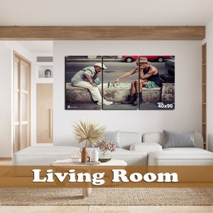 May include: A split canvas print of two men playing chess on a street in a city. The men are wearing casual clothing and hats. The print is framed and hanging on a wall in a living room.
