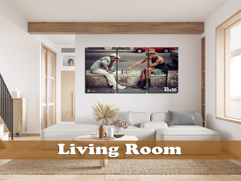 May include: A split canvas print of two men playing chess on a street in a city. The men are wearing casual clothing and hats. The print is framed and hanging on a wall in a living room.