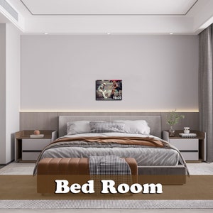 May include: A bedroom with a large bed, two nightstands, and a framed picture on the wall. The bed has a brown headboard and a white comforter. The nightstands are made of wood and have lamps on them. The picture is of two people sitting on a bench.