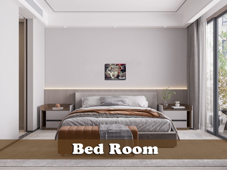 May include: A bedroom with a large bed, two nightstands, and a framed picture on the wall. The bed has a brown headboard and a white comforter. The nightstands are made of wood and have lamps on them. The picture is of two people sitting on a bench.