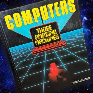 May include: A vintage book cover titled "COMPUTERS" with the subtitle "THOSE AMAZING MACHINES." The cover features a retro computer graphic in red and black, set against a blue grid and a starry background. The book is from the National Geographic Society.