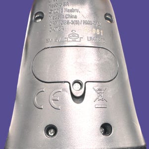 Close-up of back of doll showing Hasbro markings, battery compartment, and battery type information