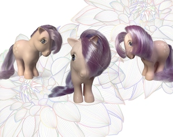 May include: Three pastel pink My Little Pony figures with purple and white hair. The ponies are standing on a white background with a colorful floral design.