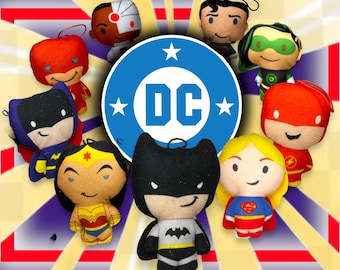 May include: A collection of plush DC Comics characters, including Superman, Batman, Wonder Woman, The Flash, Green Lantern, and Cyborg. The characters are all smiling and have a cartoonish style. The DC logo is in the center of the image.