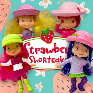 May include: Four Strawberry Shortcake dolls with different coloured hair and outfits. The dolls are wearing pink, purple, green and blue outfits. The dolls are all smiling and have strawberry-shaped noses. The dolls are standing on a blue and white background with the words "Strawberry Shortcake" written in red.