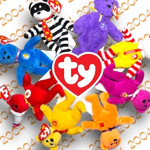 May include: A collection of colorful Ty Beanie Babies, including a purple bear, a red bear, a yellow bear, a blue bear, a white bear, a black and white raccoon, and a pink bear. The bears are arranged in a circle around a red heart with the word "ty" in white letters.