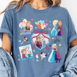 Cute coquette-style Disney Frozen shirt featuring Elsa and Anna with hearts, bows, and pastel icons, ideal for sisters and best friends.