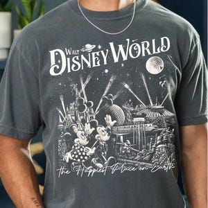 Retro Walt Disney World shirt with vintage-style illustrations of Magic Kingdom, Epcot, Hollywood Studios, and Animal Kingdom featuring classic Disney icons and park landmarks in a nostalgic line-art design.