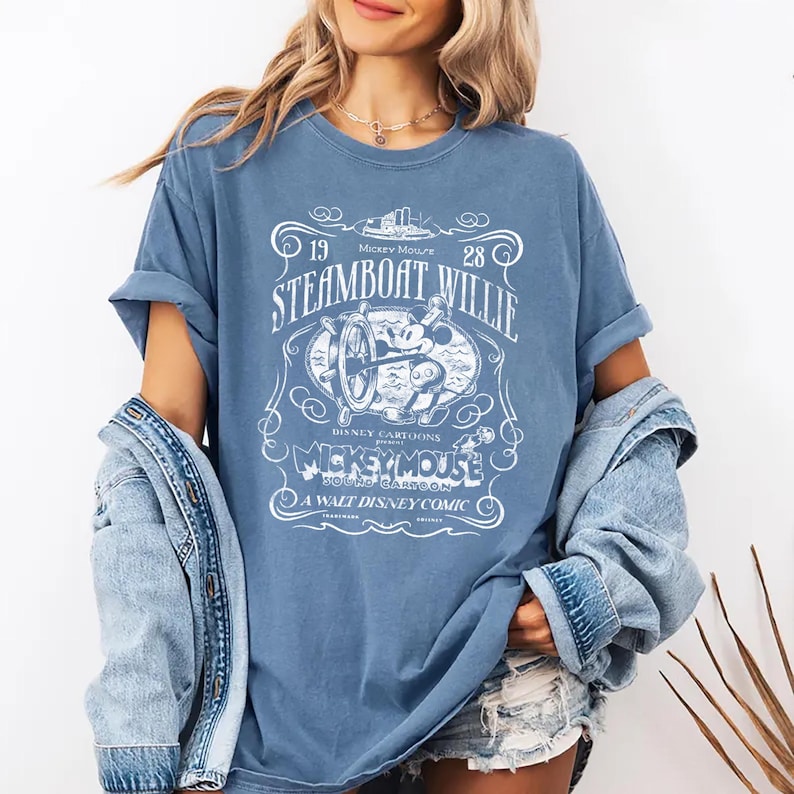 Vintage Steamboat Willie shirt featuring classic black and white Mickey Mouse steering a ship wheel, retro Disney cartoon design, perfect for Magic Kingdom trips, Disney family vacation outfits, or nostalgic Mickey Mouse birthday gifts for adults and kids.