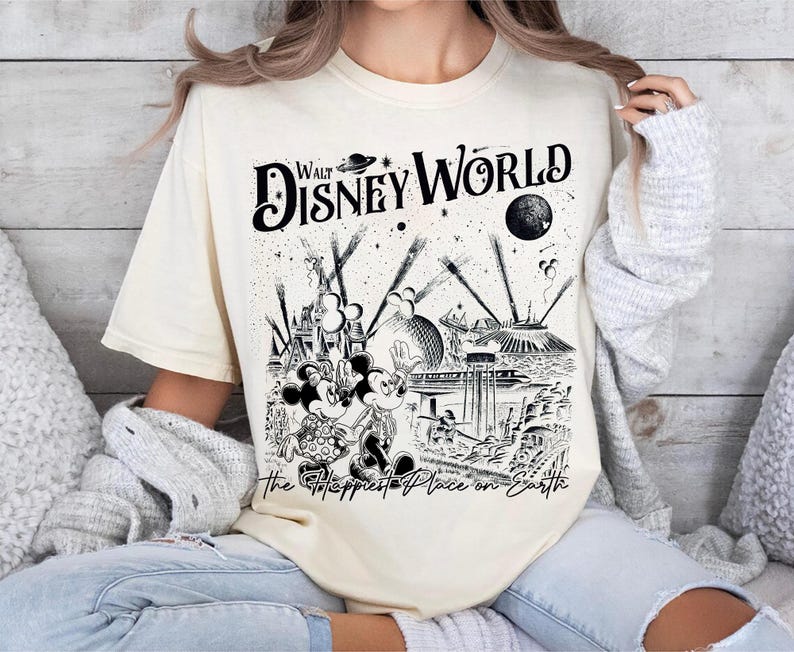 Retro Walt Disney World shirt with vintage-style illustrations of Magic Kingdom, Epcot, Hollywood Studios, and Animal Kingdom featuring classic Disney icons and park landmarks in a nostalgic line-art design.