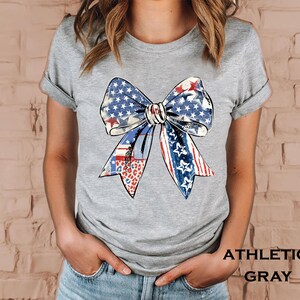 Distressed patriotic bow graphic in red white and blue with stars stripes and mixed animal print patterns perfect for USA 4th of July shirts women’s Independence Day tees America flag summer outfits cute freedom celebration apparel or red white blue patriotic shirt for parades BBQs and holiday events