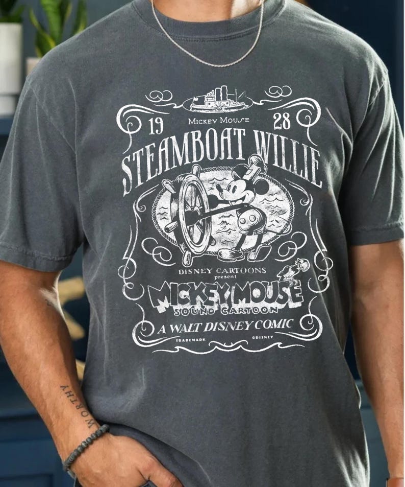 Vintage Steamboat Willie shirt featuring classic black and white Mickey Mouse steering a ship wheel, retro Disney cartoon design, perfect for Magic Kingdom trips, Disney family vacation outfits, or nostalgic Mickey Mouse birthday gifts for adults and kids.