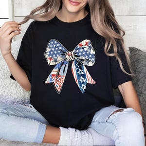 Distressed patriotic bow graphic in red white and blue with stars stripes and mixed animal print patterns perfect for USA 4th of July shirts women’s Independence Day tees America flag summer outfits cute freedom celebration apparel or red white blue patriotic shirt for parades BBQs and holiday events