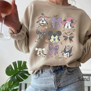 Pastel Disney Halloween shirt design featuring Mickey, Minnie, Donald, Goofy, and bows in coquette style with spider webs, candy, and spooky accents—perfect for family matching shirts and Mickey’s Not So Scary Halloween Party 2025.