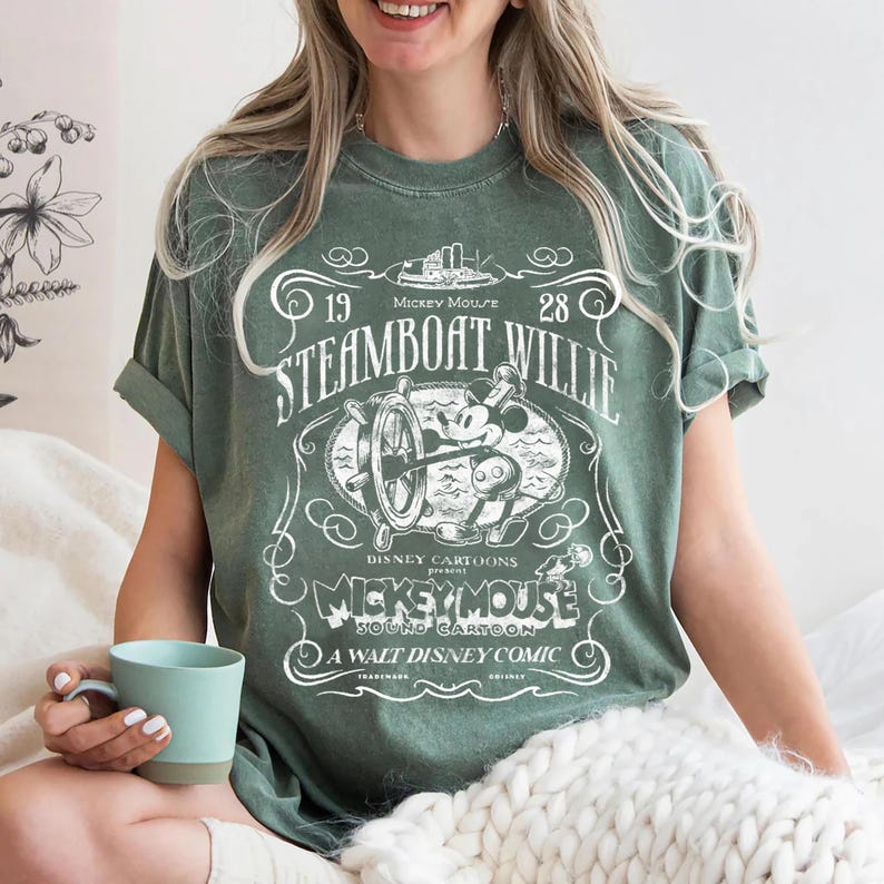 Vintage Steamboat Willie shirt featuring classic black and white Mickey Mouse steering a ship wheel, retro Disney cartoon design, perfect for Magic Kingdom trips, Disney family vacation outfits, or nostalgic Mickey Mouse birthday gifts for adults and kids.