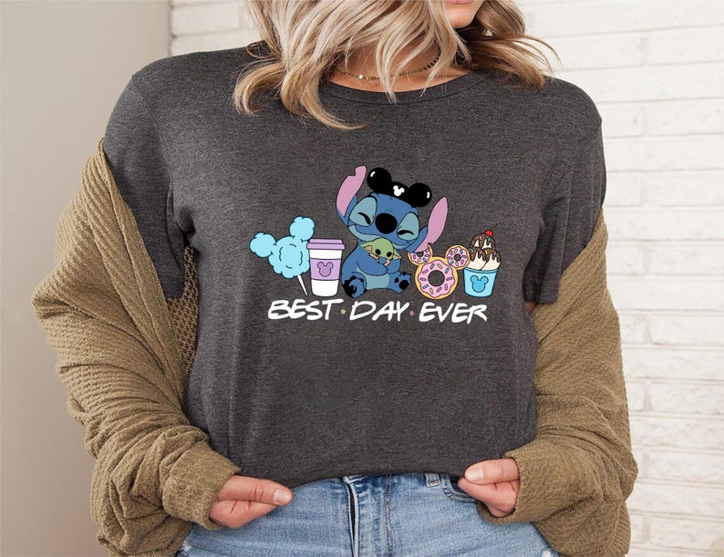 Stitch Best Day Ever Shirt featuring Stitch hugging Baby Yoda, surrounded by colorful Disney snacks like Mickey-shaped donuts, cotton candy, ice cream, and a Disney coffee cup. Cute and fun design perfect for a Disney Snacks Sweatshirt or T-shirt, great for Disney park trips, foodie gifts, and Stitch fans.