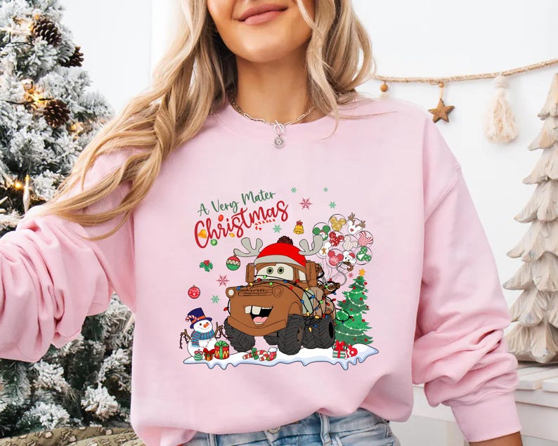 Cute Disney Cars Christmas shirt with Mater in holiday cheer, surrounded by lights and festive elements, perfect for Disney trips or holiday wear.