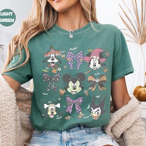Pastel Disney Halloween shirt design featuring Mickey, Minnie, Donald, Goofy, and bows in coquette style with spider webs, candy, and spooky accents—perfect for family matching shirts and Mickey’s Not So Scary Halloween Party 2025.
