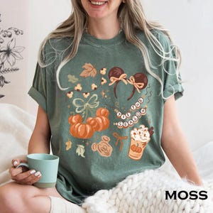 retro disney halloween shirt design featuring coquette bow mickey ears pumpkins fall leaves cozy autumn coffee cup tis the season beaded necklace and cute disney fall vibes illustration