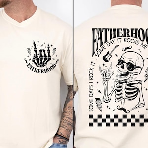 Funny Fatherhood shirt featuring rock and roll skeleton hand with sunglasses and lightning bolts, bold graphic tee for dads who love music, cool retro Father's Day shirt for first-time dad or new dad, punk dad gift t-shirt with skeleton design, Father's Day gift for husband from kids, edgy and fun dad shirt with vintage rock band vibe, fatherhood rocks themed tee for dad’s birthday or family photos