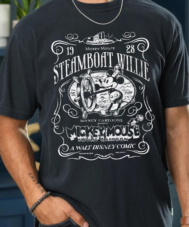 Vintage Steamboat Willie shirt featuring classic black and white Mickey Mouse steering a ship wheel, retro Disney cartoon design, perfect for Magic Kingdom trips, Disney family vacation outfits, or nostalgic Mickey Mouse birthday gifts for adults and kids.