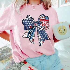 Patriotic bow shirt design with red white and blue colors stars and stripes perfect for 4th of July womens Independence Day summer outfit
