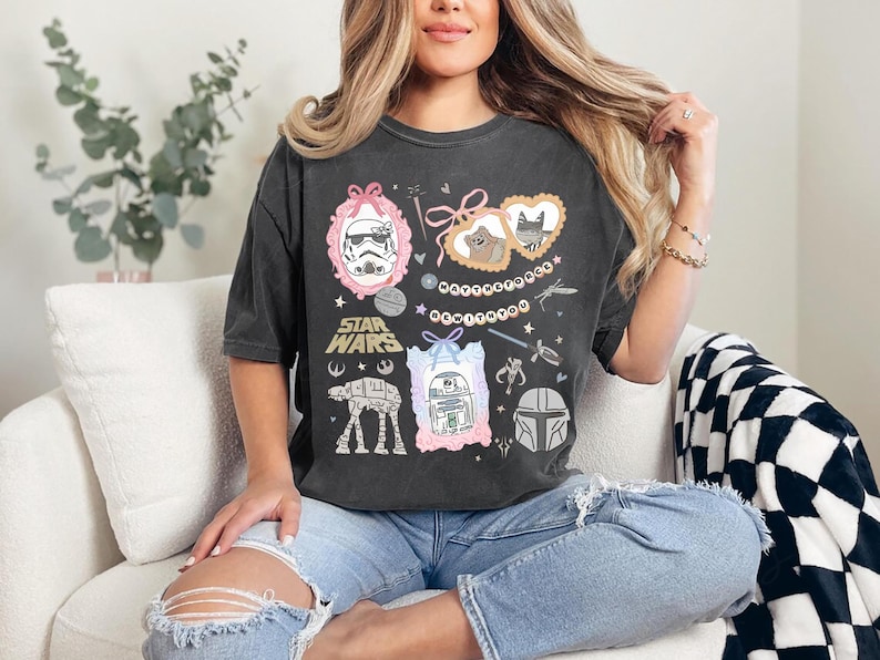 Retro pastel water color coquette Star Wars shirt with kawaii-style Stormtrooper, R2D2, AT-AT, Ewok, and Mandalorian helmet in watercolor frames with bows and hearts, perfect for Disney trip or Star Wars Day outfit.