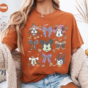 Pastel Disney Halloween shirt design featuring Mickey, Minnie, Donald, Goofy, and bows in coquette style with spider webs, candy, and spooky accents—perfect for family matching shirts and Mickey’s Not So Scary Halloween Party 2025.