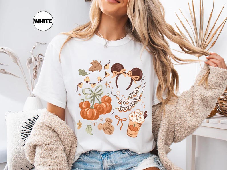 retro disney halloween shirt design featuring coquette bow mickey ears pumpkins fall leaves cozy autumn coffee cup tis the season beaded necklace and cute disney fall vibes illustration