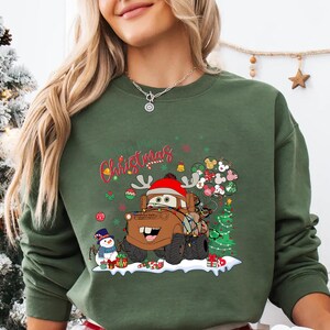 Mater Christmas holiday T-shirt from Disney Cars, featuring festive decorations, perfect for Disney trips, Christmas gifts, and holiday events.