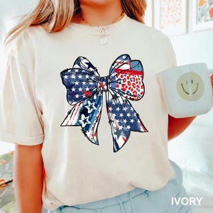 Patriotic bow shirt design with red white and blue colors stars and stripes perfect for 4th of July womens Independence Day summer outfit