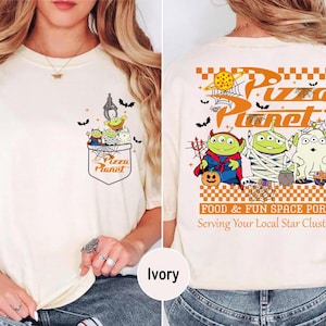 Toy Story Pizza Planet Halloween shirt front design with three green aliens dressed as devil mummy and ghost holding candy, featuring vintage Disney Halloween style for Not So Scary Party or Disneyland trip. Pizza Planet Halloween claw machine pocket design on the back of shirt with Toy Story aliens in costumes and spooky spiderweb, perfect for Disney family matching Halloween outfit and Mickey’s Not So Scary event.