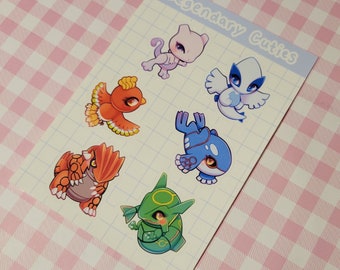 May include: A set of six colorful cartoon stickers featuring legendary Pokemon characters. The stickers are on a white background with a light blue border and the text "Legendary Cutties".