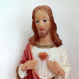 Sacred Heart statue on wooden base