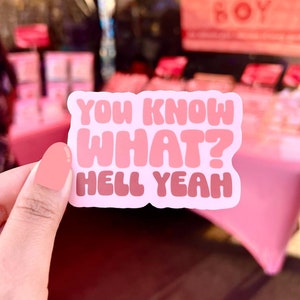 May include: Pink and white sticker with the text "You know what? Hell yeah!" in a playful font.